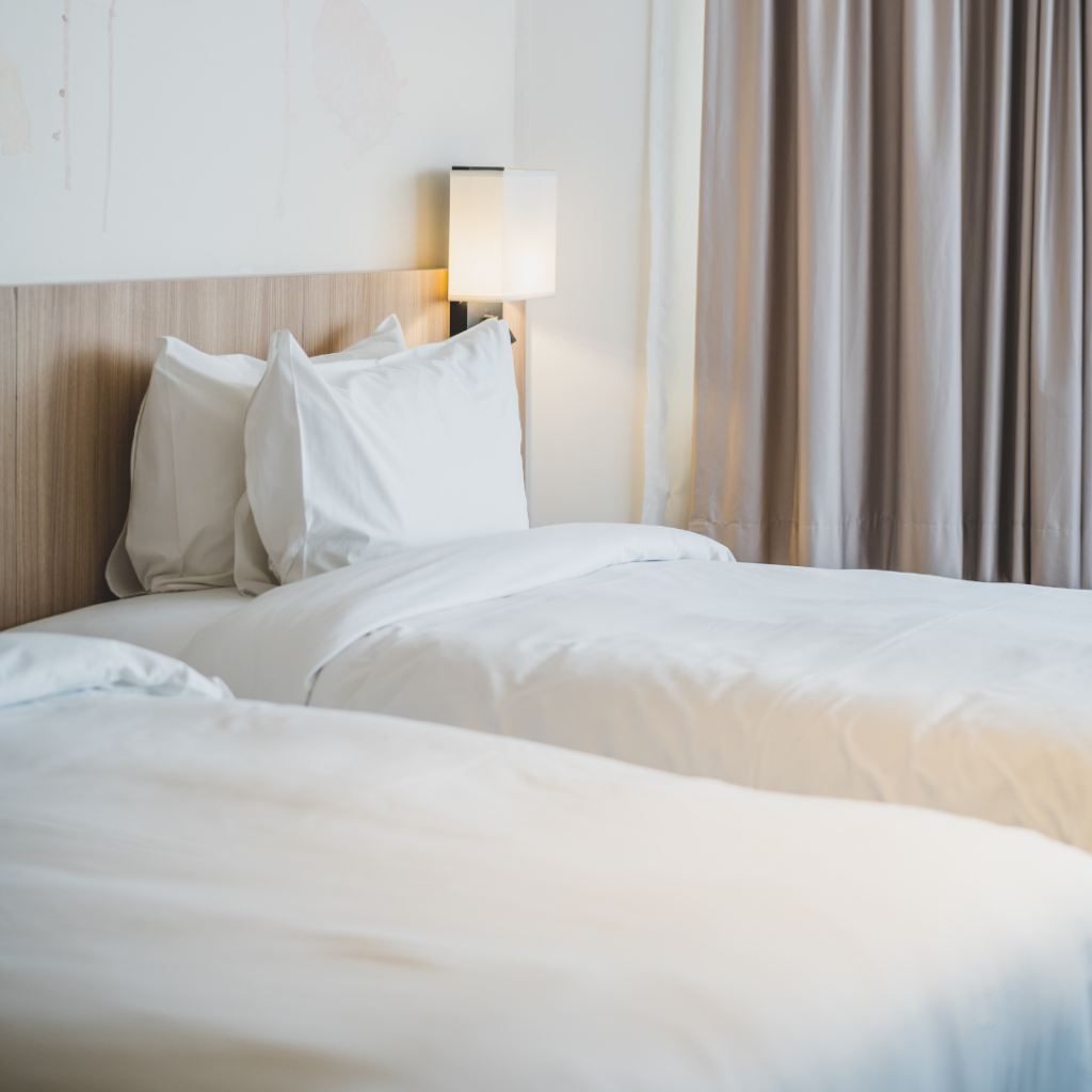 Modernes Hotelzimmer mit Kopfkissen und weißem Bettbezug